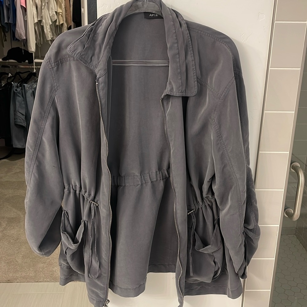 Light gray jacket with drawstring and zip up. Size XL